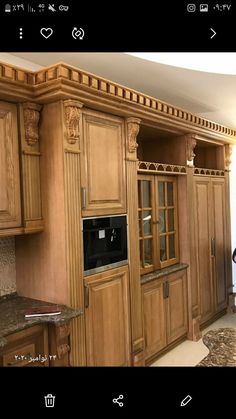 a kitchen with wooden cabinets and granite counter tops in the center is an appliance