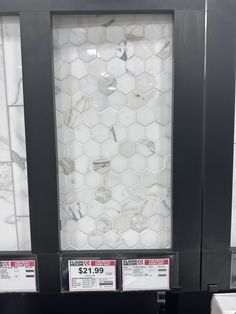 some white marble tiles on display in a store