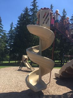 children are playing on the playground slide