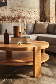 a living room with a couch, coffee table and two candles on top of it