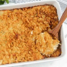 a casserole dish with cheese and parsley on the side, ready to be eaten