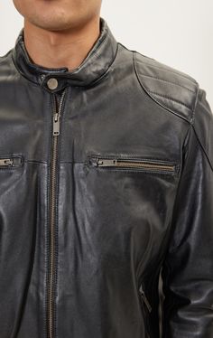 DETAILS Made from high quality leather, this jacket offers both comfortability and versatility. With a zip closure, the zippered sleeve cuff detail, and 2 chest zipper pockets, attention to detail was not spared with this design. This edgy, moto inspired jacket gives a more stylistic approach to the classic. COMPOSITION 100% Genuine LeatherMade in TurkeyStyle #71184CARESpecialist Leather Clean Only STYLE# 71184 SIZE + FITTailored fit, to find your correct size use the ''what's my size '' button. Black Biker Jacket With Zip Cuffs For Work, Black Business Leather Jacket With Zip Cuffs, Black Leather Jacket With Zip Cuffs For Business, Black Leather Jacket With Zip Cuffs For Work, Black Biker Jacket With Zip Cuffs For Winter, Casual Black Biker Jacket With Zip Cuffs, Black Winter Biker Jacket With Zipper Pocket, Black Biker Jacket With Zip Cuffs And Long Sleeves, Classic Black Biker Jacket With Zip Cuffs