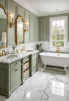 a bathroom with marble counter tops and green cabinets, along with a claw foot tub