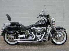 a black and silver motorcycle parked in front of a building