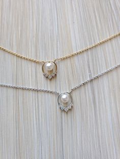 "Simple Dainty 5 Stones Frame Pearl Necklace Can't decide you want stone or pearl? Why not both! The pearl looks like it is just floating in the middle of the necklace.  Chain Length: 15 1/2\" (39.0 cm) + another 2\" (5.0 cm) extension Chain Width: 1 mm Pendant Length: 7/16\" (1.1 cm) Pendant Width: 5/16\" (0.8 cm) Weight: 2g Material: rhodium plated, 14K gold plated or rose gold plated over brass, cubic zirconia, imitation pearl" Metal Pearl Drop Necklace, Metal Pearl Charm Necklace, Dainty Metal Jewelry With Pearl Pendant, Delicate Metal Pearl Chain Jewelry, Round Pearl Chain Jewelry, Dainty Pearl Necklace With Chain For Wedding, Round Pearl Charm Necklaces, Pearl Charm Necklaces With Round Shape, Elegant Metal Charm Necklace With Pearl Pendant