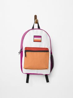 a small backpack hanging on a wall