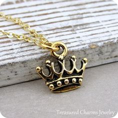 This Royal Crown Charm necklace comes on a gold-plated chain that is available in different lengths. Please choose your desired length from the drop-down menu when placing the item in your shopping cart. { CHARM DETAILS }★ Material: Pewter ★ Finish Color: Gold★ Measurements: 1/2" x 1/2"★ Dimensions: Double-sided★ Made in the USA{ SIMILAR ITEMS } More royal themed items available from my shop: https://www.etsy.com/shop/treasuredcharms/search?search_query=royal{ GIFT OPTIONS}Gift boxes are availab Nickel-free Gold Brass Charm Necklaces, Gold Spiritual Charm Necklace, Gold Nickel-free Charm Necklaces As Gift, Gold Brass Charm Necklace For Gift, Gold Dangle Charm Necklaces For Mother's Day, Gold Jewelry With Lobster Clasp For Birthday, Gold Personalized Spiritual Charm Necklaces, Gold Tarnish Resistant Jewelry For Birthday Gift, Gold Metal Jewelry For Birthday Gift