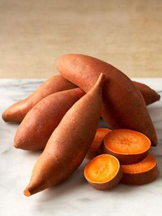 there are carrots and sweet potato slices on the counter top next to each other