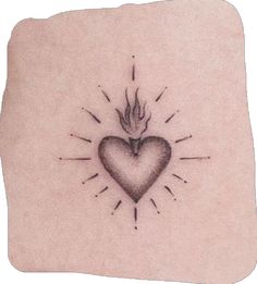 a small heart tattoo on the back of a woman's left arm, with an arrow