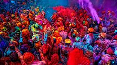 many people are covered in colored powder and paint