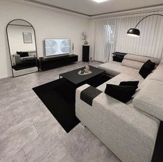 a modern living room with black and white furniture