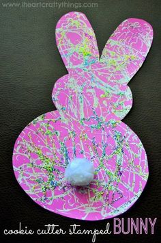 an easter bunny craft made out of cookie cutters and colored paper with sprinkles