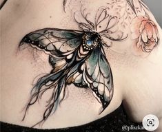 a woman's stomach with a butterfly tattoo on it and flowers around the breast