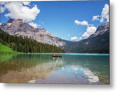 a boat on a lake with mountains in the background metal print by panoramic images