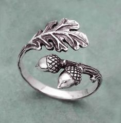 This sterling silver oak leaf-acorn ring is perfect for a gardener, plant enthusiast, tree lover, or simply one who thrives on being in nature and the outdoors. The oak tree, sacred to many ancient cultures, especially the Druids, signifies wisdom, strength, endurance, and victory. As pictured, this ring is a size 6 and is fully adjustable. If you have a specific size in mind, please leave a note and I will re-size it for you. Gargoyle Character, Acorn Ring, Bracelet Rings, Fantasy Earrings, Silver Leaf Ring, Necklace Aesthetic, Aesthetic Gold, Aesthetic Rings, Fall Rings