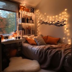 a bedroom with lights on the wall and a bed in front of a large window