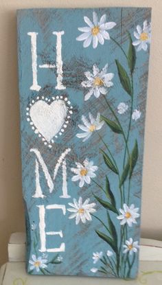 a painted sign that says i love me with daisies