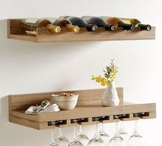 two wooden shelves holding wine glasses and bottles