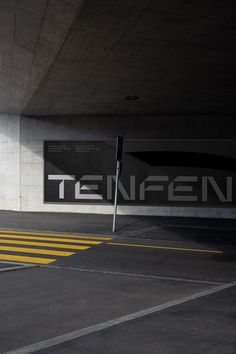 an empty parking garage with the word ten fifteen on it's sign in front