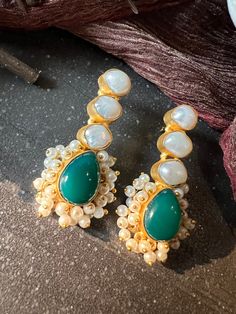 One of our favorite picks! The gorgeous studs are beautifully handcrafted by our skilled Indian craftsmen from Jaipur in the finest quality of gemstones and gold plated. Material: Brass, Pearls, Gold Polish The length of the earrings is 5.5 cm  The weight of the earrings is 22 grams per pair Fusion Style Kundan Pearl Earrings For Gift, Festive Handmade Formal Earrings, Festive Formal Handmade Earrings, Fusion Style Pearl Earrings For Festivals, Traditional Jewelry With Gemstone Accents For Party, Gold Earrings With Stones For Formal Occasions, Fusion Style Pearl Drop Danglers As Gift, Fusion Pearl Earrings Gift For Diwali, Elegant Gold-plated Stone Setting Earrings