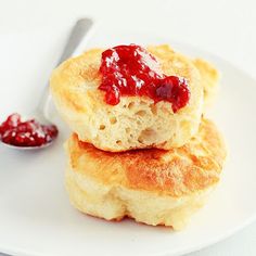 two biscuits on a white plate with jam