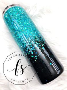 a blue and black bottle with glitter on it