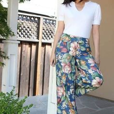 a woman in white shirt and floral print pants