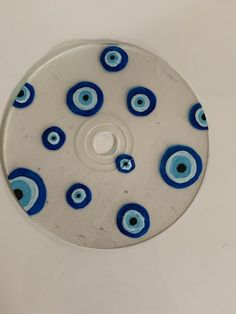 a glass disk with blue and white designs on it