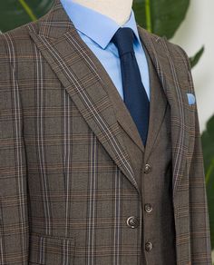 Color: brown plaid Material: 63% polyester, 34% viscose, 3% elastane Suit includes: blazer, vest, and pants Single-breasted suit (2-button blazer) Lapel type: peak lapels Jacket interior lining option: fully-lined Jacket vent: single vent Fitting: slim-fit Care instructions: dry clean only Machine washable: no Bow Tie Suit, Modern Fit Suit, Suit Styles, Suit Stores, Vest And Pants, Slim Fit Suit Men, Plaid Material, Tuxedo Blazer, Lapel Jacket