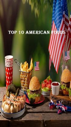 an american picnic with sandwiches, fries and other foods on the table in front of flags