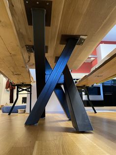 a wooden table with metal legs on the floor