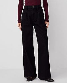 A modern jean with a perfect drape and high waist that endlessly flatters. Front zip with double hook-and-bar closure. Belt loops. Front double pleats. Front off-seam pockets. Back besom pockets.,Leg Shape:Trouser – a pant with a bit of flare that lengthens legs,Rise:High rise: sits 1/2" to 1" below natural waist,Imported:Imported,Fit:Relaxed & easy,Length:Full length: 31" inseam with 25" leg opening,Fabrication:98% Cotton, 2% Elastane,Garment Care:Machine Washable The Pleated Trouser by Ann Tay Affordable High-waist Black Dress Pants, Tailored Black Ankle-length Dress Pants, Elastane Tapered Leg Pull-on Dress Pants, Black Straight Leg Pull-on Bottoms, Black Tapered Leg Pants With 4-way Stretch, Ann Taylor, Classic Black, Size 12, Size 10