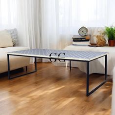 a coffee table sitting on top of a hard wood floor next to a white couch