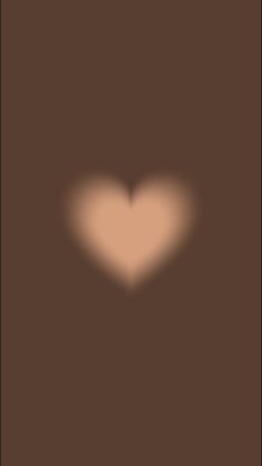 the shadow of a heart on a brown background