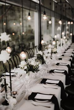 a long table is set with black and white place settings