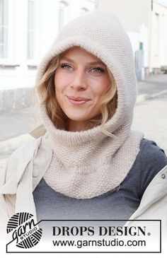 a woman wearing a white knitted hood and scarf over her face with the words drops design on it