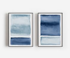 two blue watercolor paintings hanging on the wall