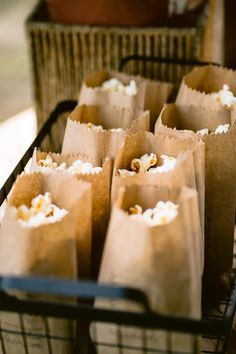 small brown paper bags filled with popcorn