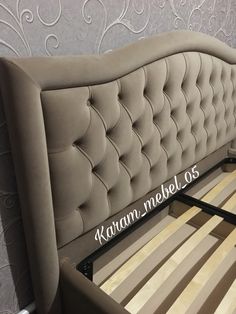 an upholstered bed frame with wooden slats