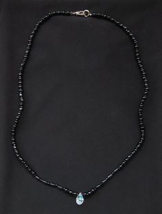 Black Bead Necklace with Crystal 18" This cute, simple necklace is made of black beads and a single teardrop shaped crystal. The silver clasp works perfectly. Measures 18". Adjustable Black Beaded Crystal Necklace, Black Beaded Jewelry With Oval Beads, Black Oval Beaded Necklaces, Black Beaded Necklaces With Lobster Clasp, Black Jewelry With Lobster Clasp And Round Beads, Black Jewelry With Faceted Oval Beads, Minimalist Black Beads For Gifts, Minimalist Black Beads For Gift, Minimalist Black Beads As Gift