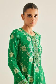 Emerald green brocade kurta with all over varied floral woven pattern and zardozi embroidered yoke. Paired with brocade trousers and organza embroidered dupatta.
Components: 3
Pattern: Woven and Embroidered
Type Of Work: Floral Pattern and Zardozi Work
Neckline: Round Neck
Sleeve Type: Full Sleeves
Fabric: Brocade, Organza, Georgette
Color: Emerald Green
Other Details: 
Attached lining
Potli and contrast border
Side slits
Embroidered sleeve borders
Length:
Kurta: 48 inches
Trouser: 38 inches
Kur Transitional Green Saree With Intricate Embroidery, Festive Pista Green Blouse Piece With Intricate Embroidery, Fitted Silk Sharara With Motifs, Festive Pista Green Blouse With Resham Embroidery, Festive Green Traditional Wear With Intricate Embroidery, Green Blouse Piece With Resham Embroidery For Transitional Seasons, Traditional Straight Kurta Blouse For Festive Occasions, Green Embroidered Kurta For Diwali, Transitional Green Blouse Piece With Resham Embroidery