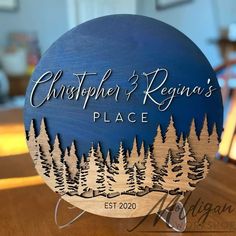 a wooden sign that says, christpher and regina's place with trees on it