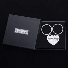 two heart shaped key chains in a gift box