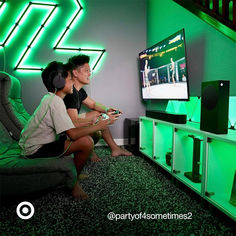 two people sitting in front of a tv playing video games