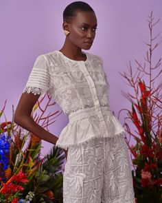 Made from airy cotton that’s intricately embroidered with blooming flowers and delicately pleated on the sleeves, our Malaga top features a soft round neck, lined buttons and fit and flare silhouette. Floral Embroidery Lace Top With Short Sleeves, Feminine Summer Lace Top With Lace Cuffs, White Broderie Anglaise Lace Top With Short Sleeves, Summer Wedding Tops With Lace Cuffs, White Feminine Blouse For Garden Party, Feminine White Blouse For Garden Party, Feminine Fitted Embroidered Top With Short Sleeves, Spring Cotton Lace Blouse, White Ruffled Blouse For Garden Party