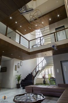 a living room filled with furniture and a spiral staircase