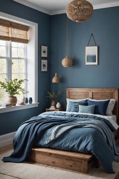 a bedroom with blue walls and wooden bed frame in the center, along with two plants on either side of the bed