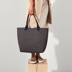 Sustainability is our signature. Our lightweight tote in a black and graphite logo pattern is knit with a unique blend of 100% recycled materialsand features easy top handles and a handy key leash for an ultra-durable, washable style. Black Lightweight Casual Bag, Lightweight Casual Black Bag, Casual Black Lightweight Bag, Black Athleisure Bag For Everyday Use, Black Athleisure Bag For Everyday, Logo Pattern, Large Tote Bag, Bag For Women, Large Tote