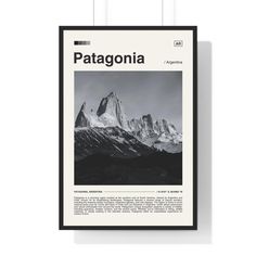 a black and white photo hanging on the wall next to a framed poster that says patagonia