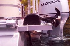 the motor boat is parked in the water by the dock with it's front end out